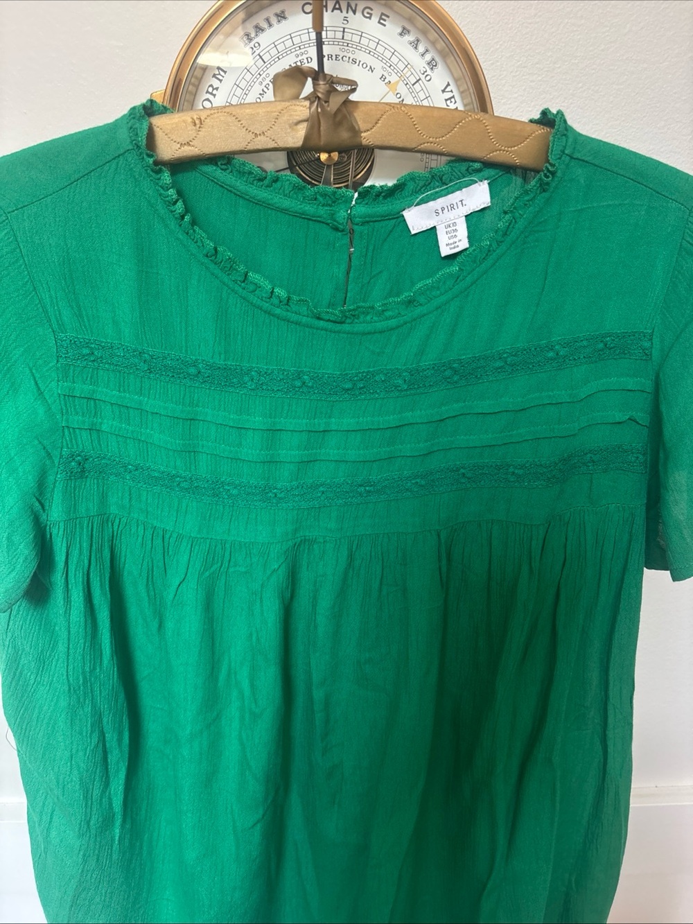 lace-trimmed neckline and pleated detailing across the chest blouse by Spirit UK